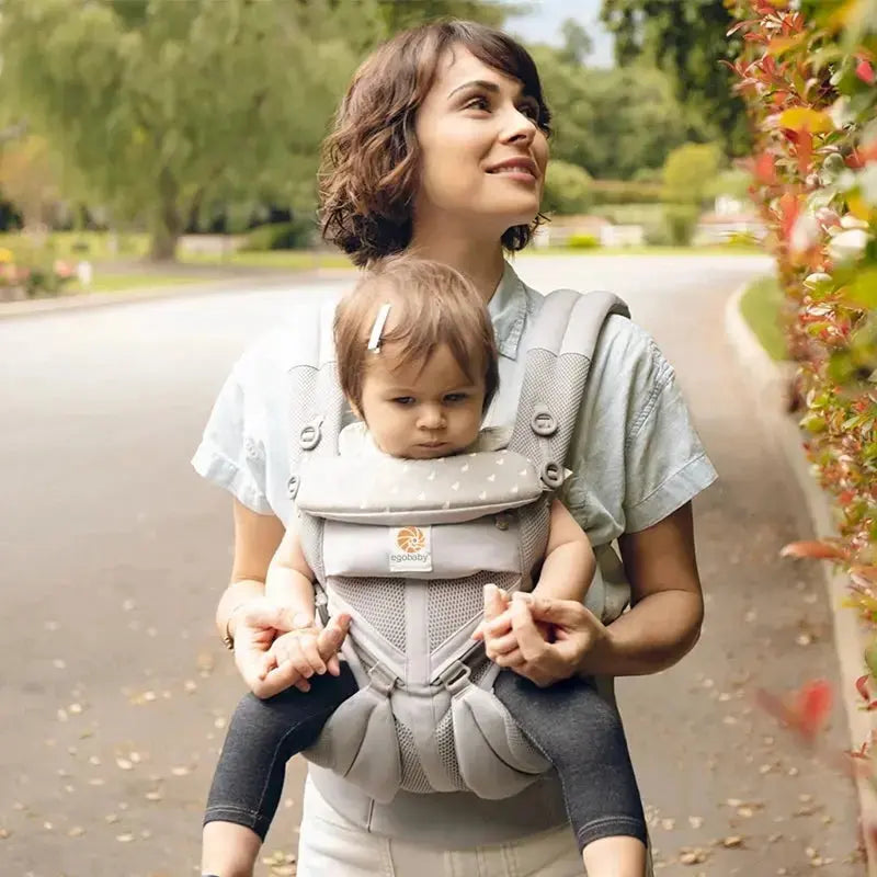 femme marche dans la rue avec bebe porte bebe